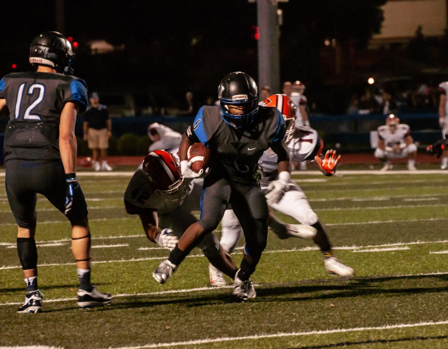 Jazontae Howard (Center) dodging Carroll Pioneers. Jordan Smith (Left) would score a touchdown on the next play.