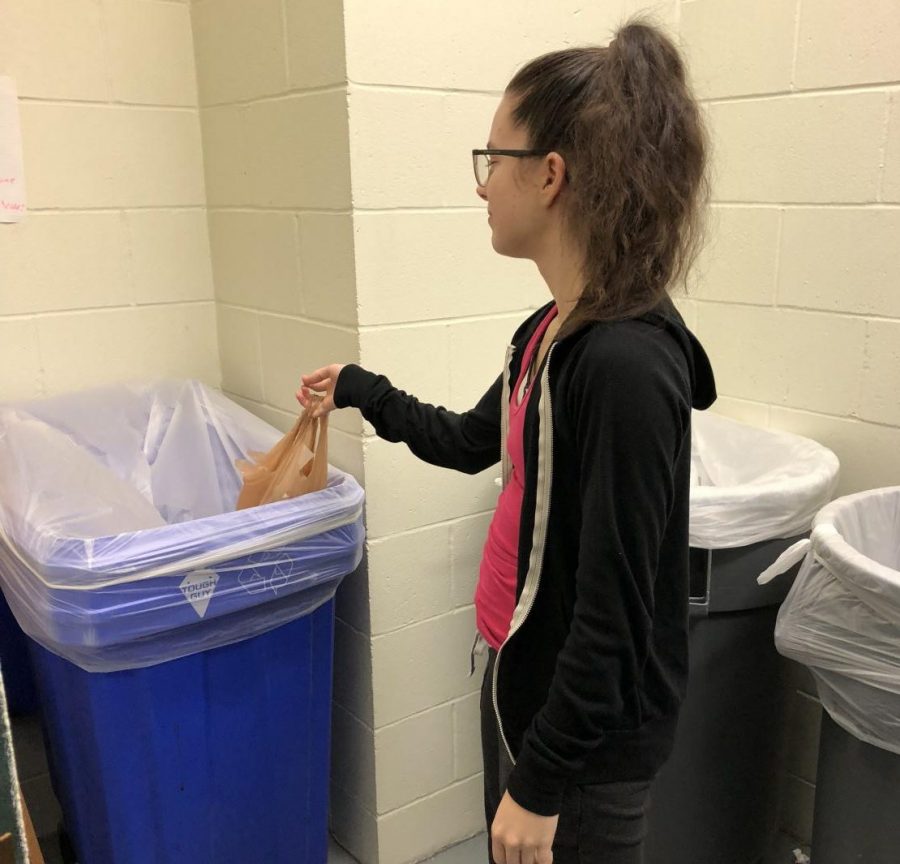 Josie Hand dispenses her recyclables in a proper recycling bin in Dolson Hall - or does she?