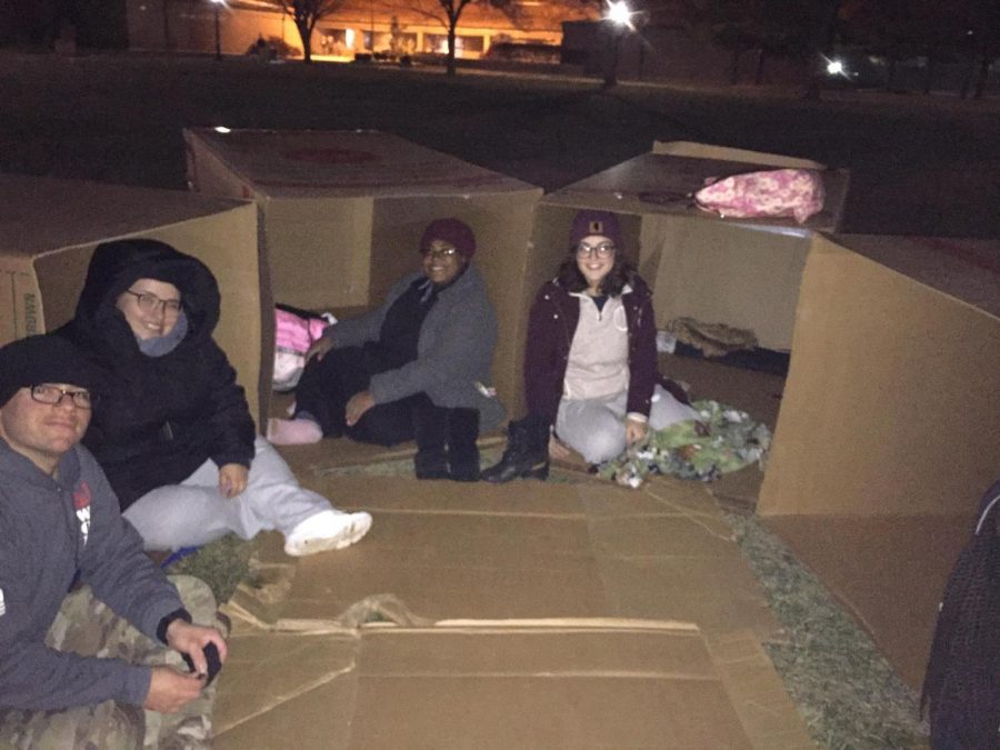 A group of 4 students sitting inside their boxes.