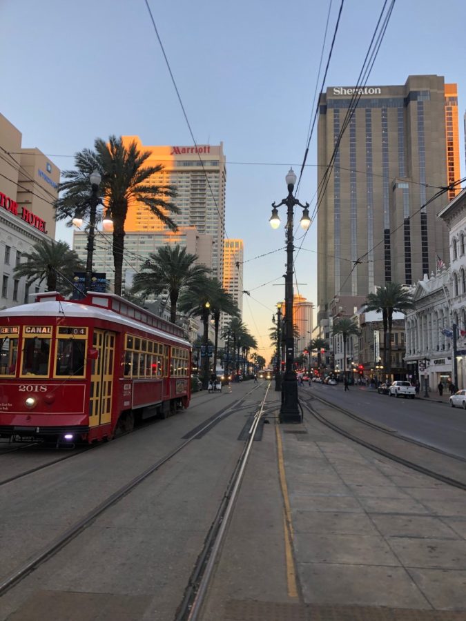 A city street with a red streetcar.