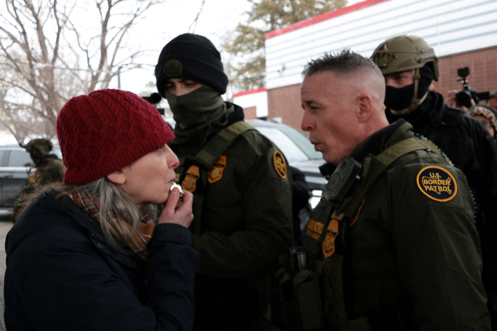 A woman blows a whistle in front of Border Patrol commander Greg Bovino, at a gas station, as immigration enforcement continues after a U.S. Immigration and Customs Enforcement (ICE) agent fatally shot Renee Nicole Good on January 7, in Minneapolis, Minnesota, U.S., January 21, 2026. REUTERS/Evelyn Hockstein 